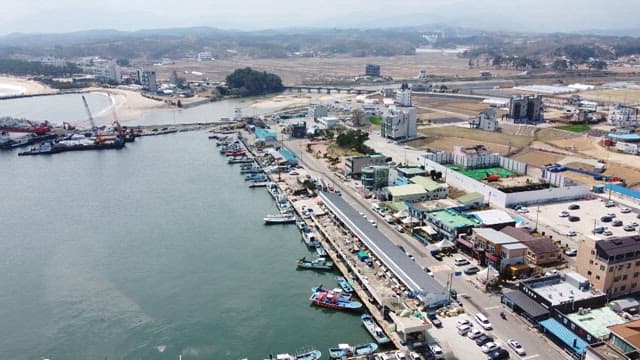 Coastal Town with Industrial and Urban Development