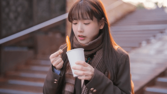 Student eating tteokbokki in winter