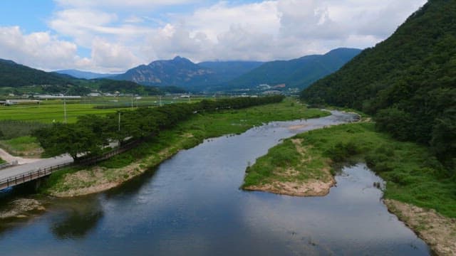 Scenic river flowing through lush fields