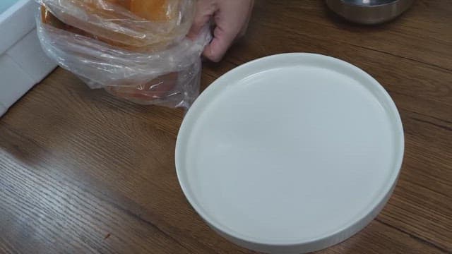 Placing fresh kimchi on a white plate