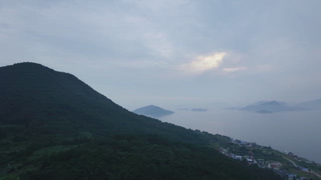 Misty mountains and sea at dawn