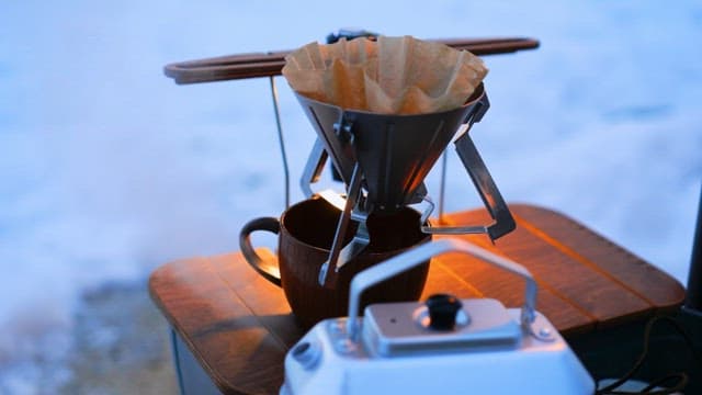 Making coffee with portable gears outdoors on a snowy day