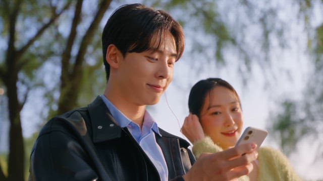 Couple checking their smartphones on a park bench