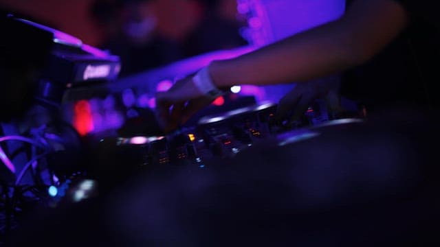 DJ Working Hard on Mixer for Club Performance