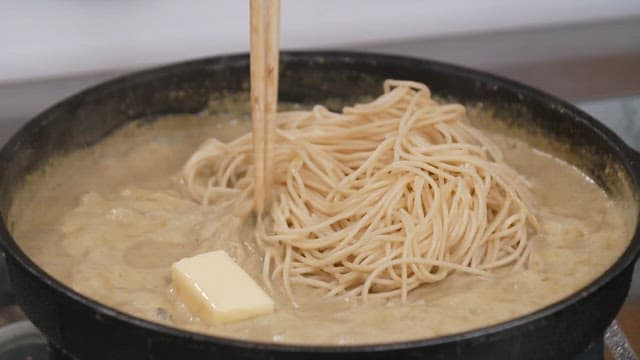 Cooking creamy pasta with butter on the pan