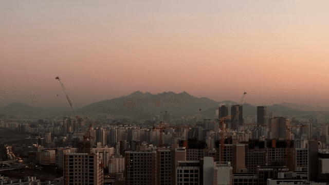City skyline with mountains at sunset