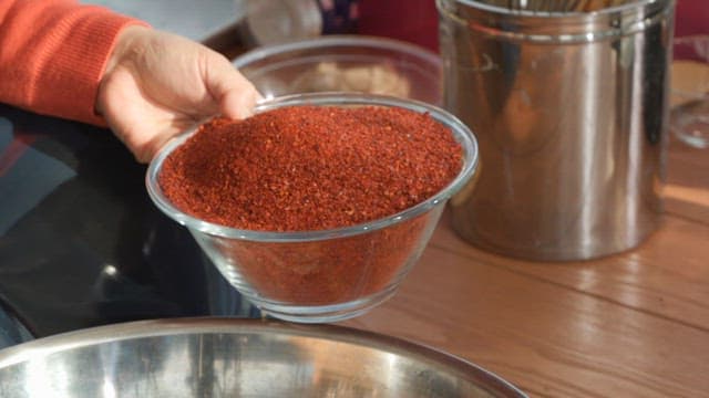 Mixing red pepper powder with shrimp paste and minced garlic