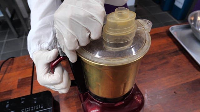 Finely ground red beans in a multi-purpose blender on the kitchen counter