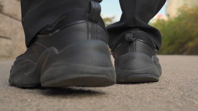 A Person Walking Along An Urban Pathway