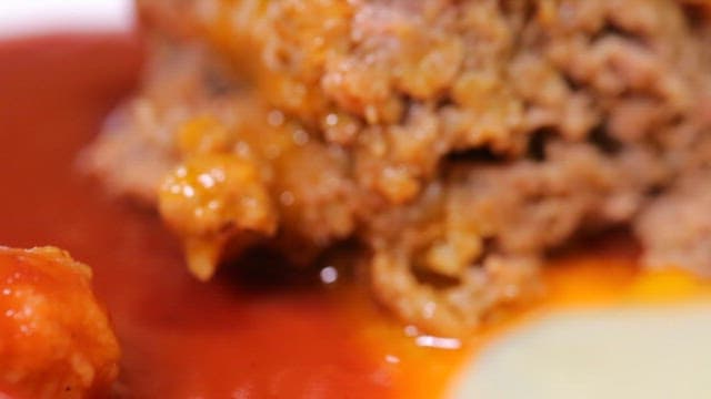 Juicy hamburger steak with a fried egg and sauce