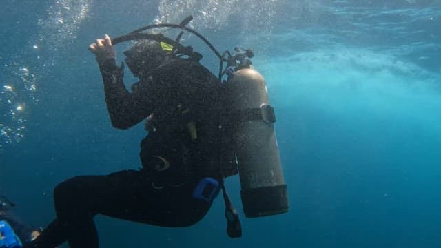 Scuba diver exploring the blue sea with an oxygen tank