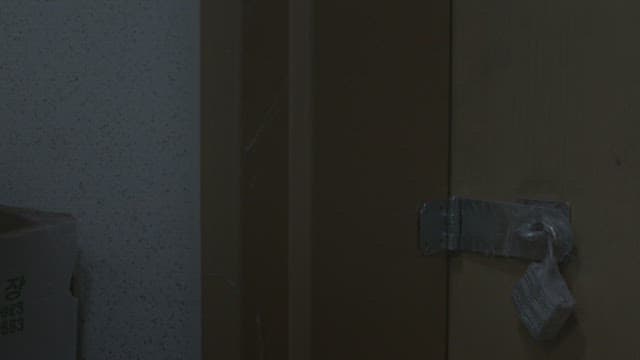 ㄴtudent in uniform unlocking a padlock