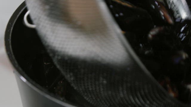 Fresh mussels in a black pot for cooking