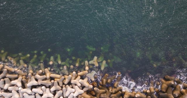 Waves crashing against concrete barriers
