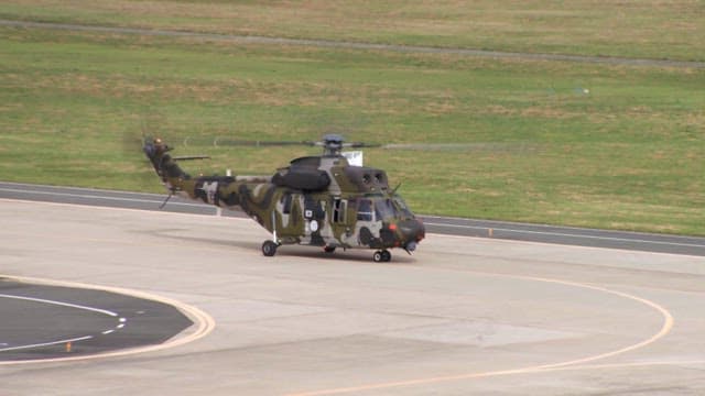 Military helicopter running on an airstrip in the afternoon