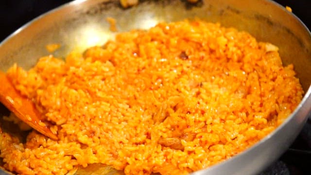 Kimchi fried rice being stirred in a pan