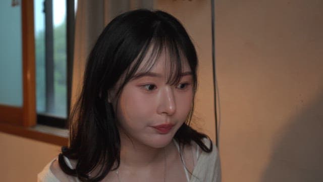 Woman applying skincare indoors