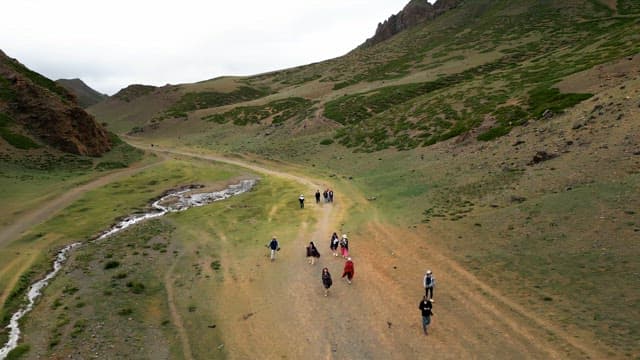 People walking through a scenic valley