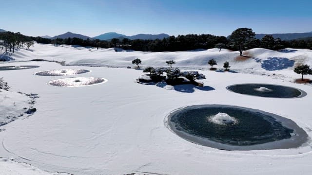 Snow-covered Landscape with Serene Ponds