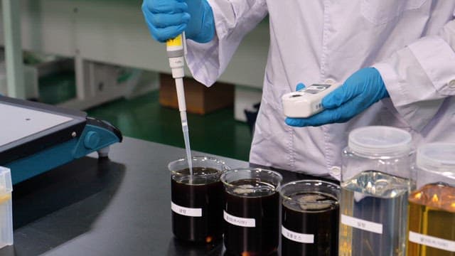 Scientist testing different types of honey with a glucose tester in the lab