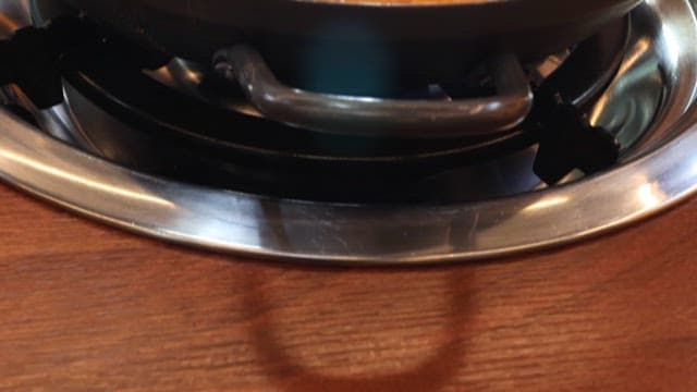 Spicy fish stew boiling on a restaurant table