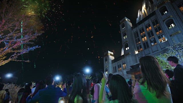 People enjoying fireworks in the city at night