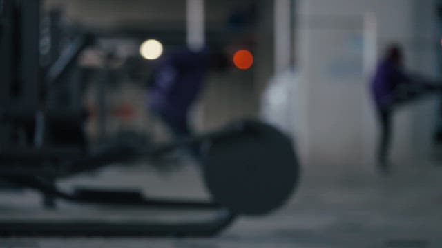 People exercising on outdoor gym equipment