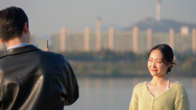 Woman posing for a photo by the river