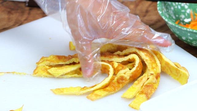 Yellow fried egg arranged on a cutting board