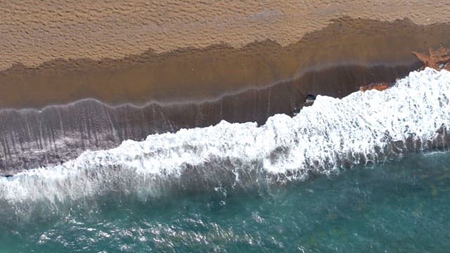 Waves crashing on a sandy beach