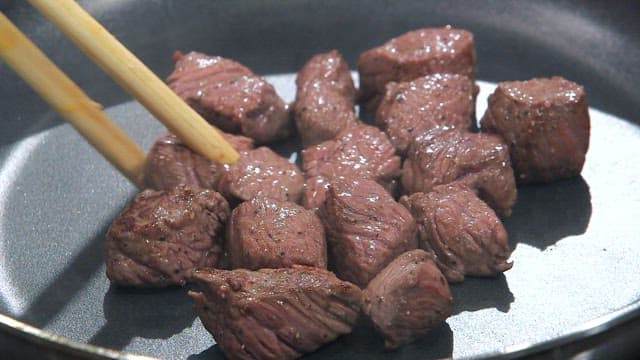 Cooked beef cubes in a pan