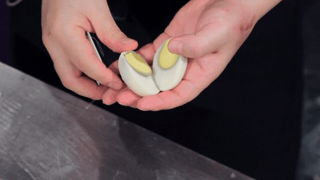 Slicing a peeled boiled egg