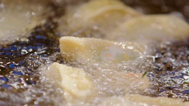 Close-up View of Frying Dumplings in Oil
