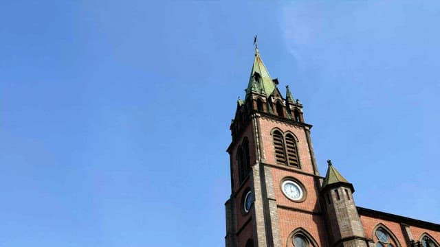 A tall historical cathedral tower under clear sky