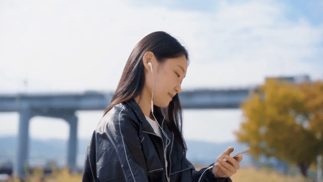 Woman listening to music outdoors