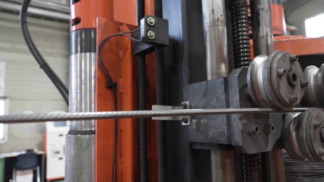 Metal rod being processed in a machine