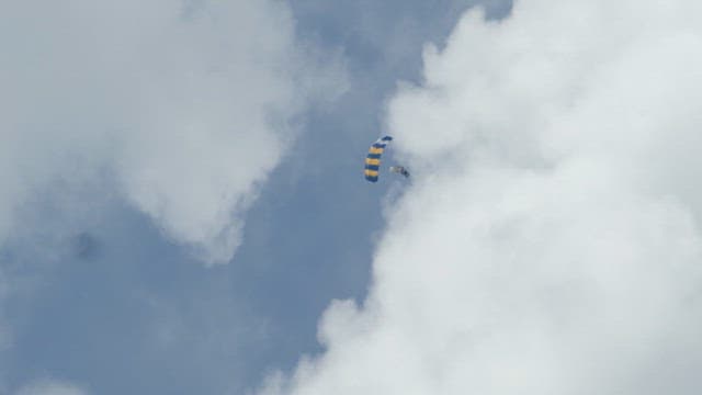 Skydiver descending with a parachute