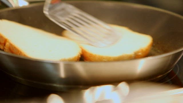 Flipping Bread Slices on a Hot Frying Pan