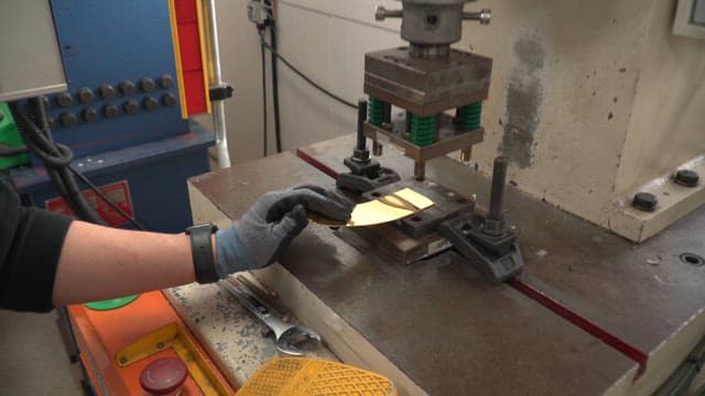 Metal sheet being pressed in a machine