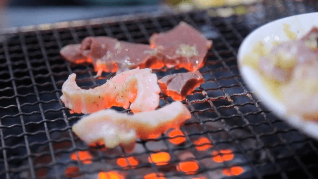 Beef tripe grilled over briquette fire