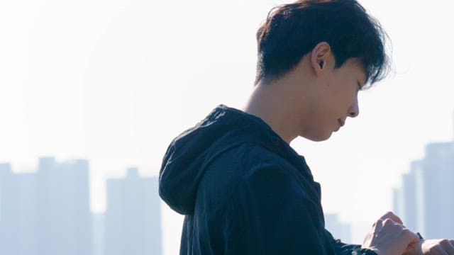 Man checking smartwatch outdoors