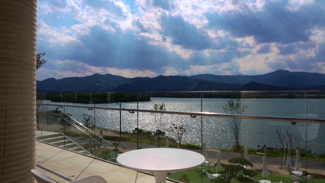 Riverside with sunlight shining through clouds