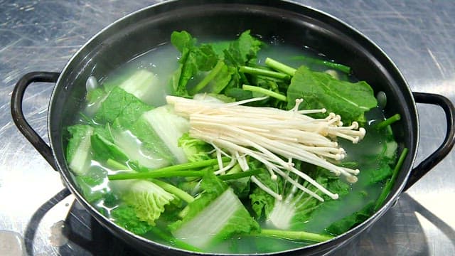 Vegetables and mushrooms boiling in a pot