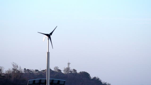 Small wind turbines spinning under the evening sky