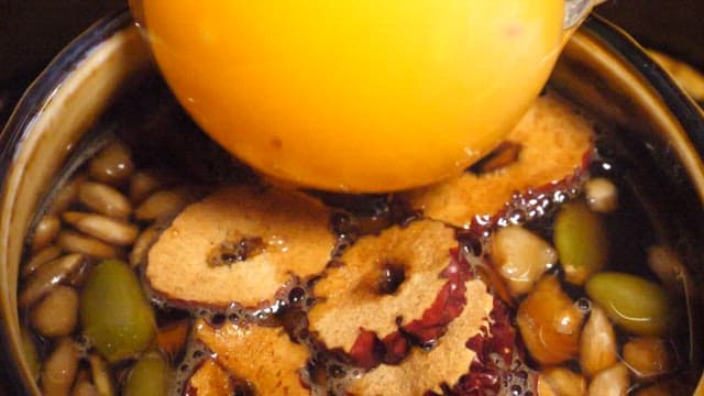 Yolk Put in Ssanghwatang with Floating Nuts