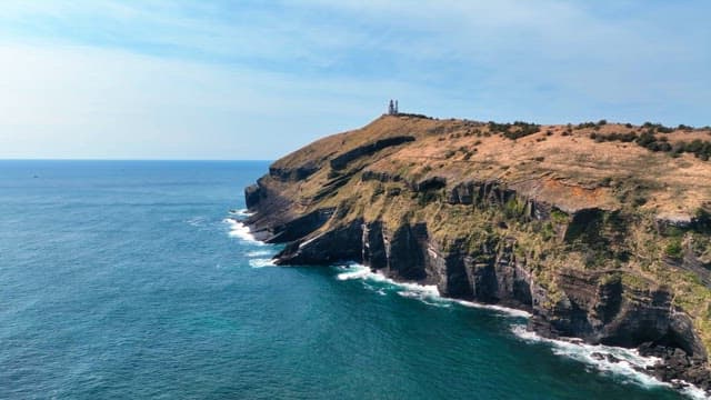 Scenic coastal cliff with a lighthouse