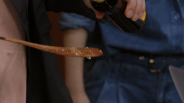 Cooking fried rice in a wok with wooden spatula