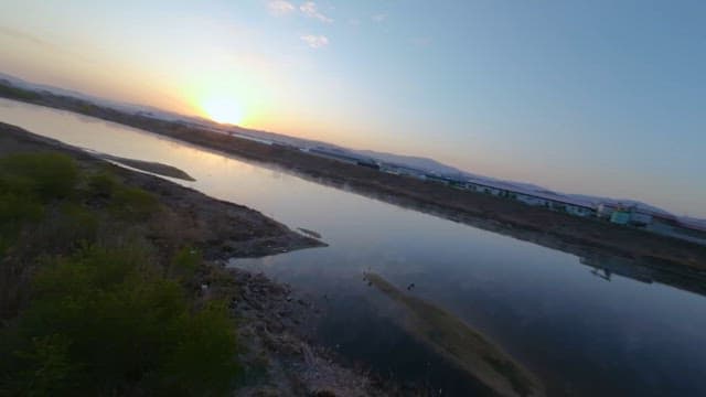 Serene Sunrise Over a Calm River Landscape