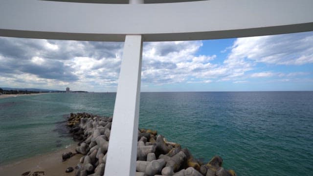 Beach and colorful breakwater seen from inside the structure