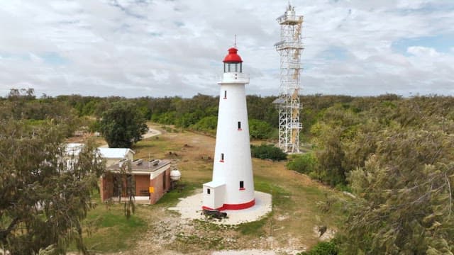 Lighthouse on a small island surrounded by the sea
